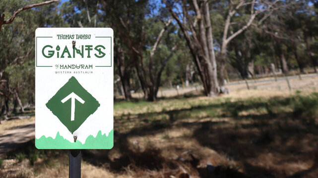 Mandurah, Western Australia, Australia - December 31 2025: Directional sign. Thomas Dambo's Giants of Mandurah. Outdoor art. Free of charge, not cost, promote tourism. Dog-friendly family adventure
