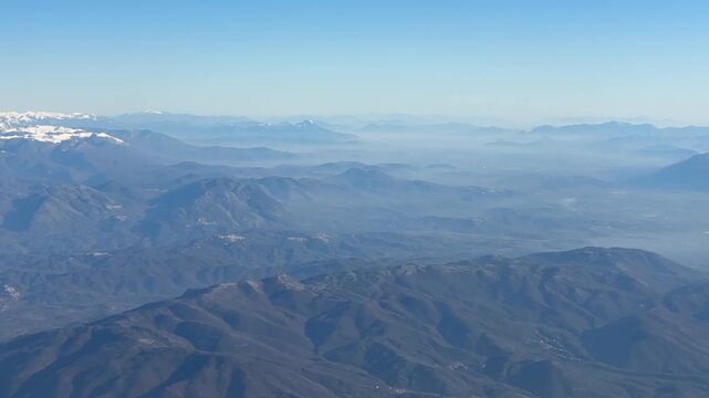 Colli Albani mountains aerial view blue sky misty landscape from airplane window over Rome Italy, volcanic hills natural terrain concept of geography, aviation, nature
