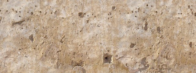Obraz premium Distressed stucco wall surface showing bullet holes damage