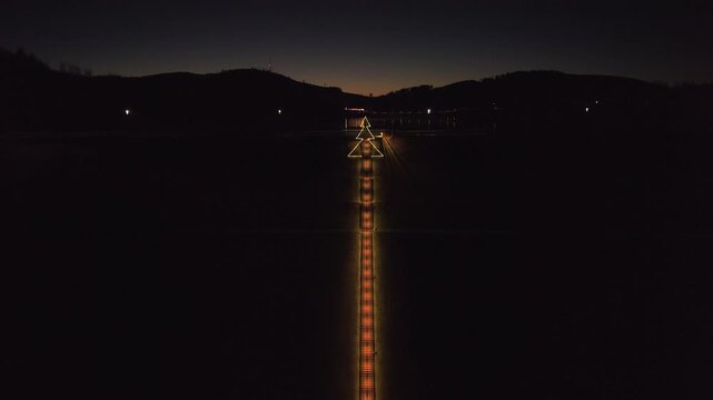 Aerial 4K view of the massive Hennesee dam and its iconic sky stairs during night. Geometric architecture meets peaceful lake landscape.