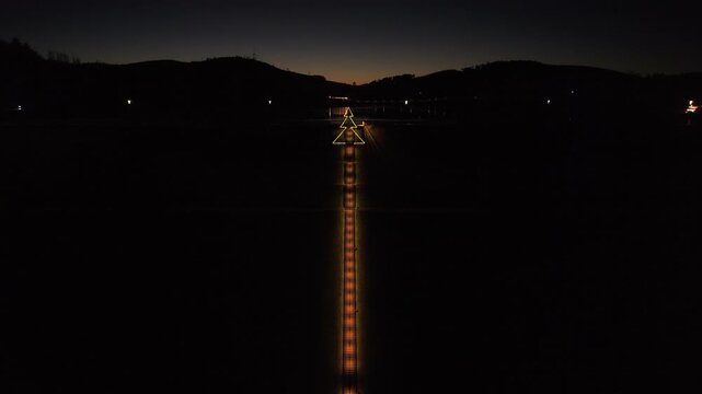 Cinematic drone flight along the illuminated Himmelstreppe stairs in Meschede at sunset. 333 steps leading to the Hennesee dam wall.