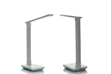 Table LED lamp with batteries isolated on white background, close-up.