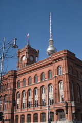 Rotes Rathaus and Fernsehturm Juxtaposition - Classic Rotes Rathaus building and the modern Fernsehturm tower against a clear blue sky, showing Berlin's architectural contrast.