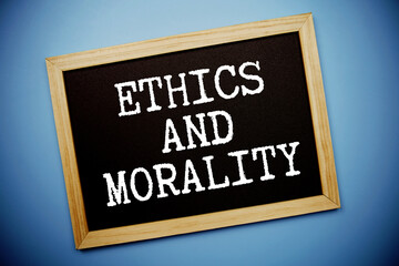 Obraz premium Ethics And Morality text written on chalkboard flat lay on blue background