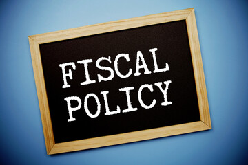 Fiscal Policy text written on chalkboard flat lay on blue background