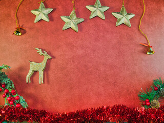 Christmas Red Background Glitter Decor - Vibrant red Christmas background with sparkling gold stars, glitter reindeer, festive garland. Perfect for holiday greetings, banners & designs. Copy space.
