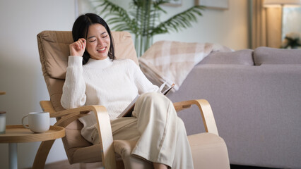 Young woman enjoying a peaceful reading session at home.