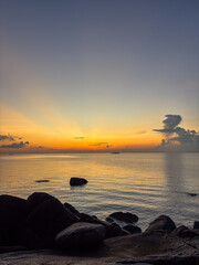 Peaceful Morning Sunrise at Rocky Beach with Soft Golden Light