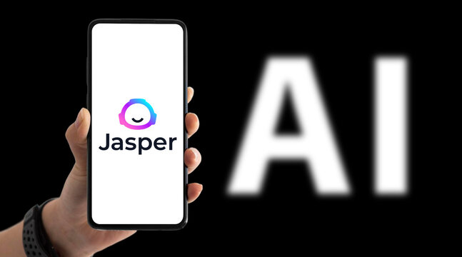 Hand holding smartphone with Jasper AI app on screen