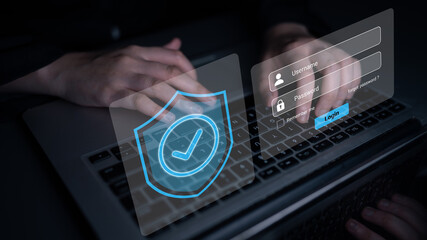 A person types on a laptop keyboard while a digital interface displays a shield symbol and a login form, emphasizing the importance of cybersecurity in online activities. Gantry