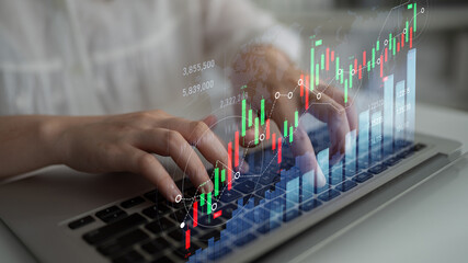 A focused individual types on a laptop, showcasing a stock market graph overlay that highlights financial growth trends and data-driven analytics in a digital workspace. Scalp