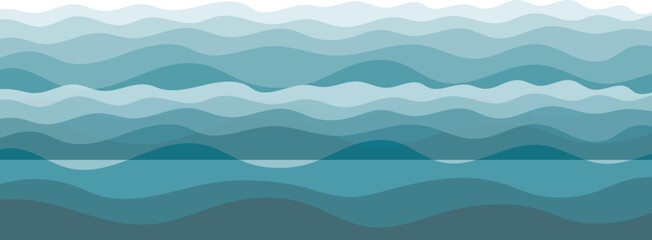 Calm sea waves in the foreground with misty mountains, hills, and a blue sky at sunrise creating a peaceful natural landscape