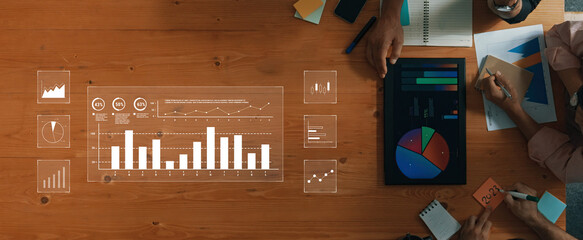 A modern office scene showcasing professionals collaborating on data analysis with various charts and graphs. Digital interfaces enhance strategic planning and teamwork. Trope