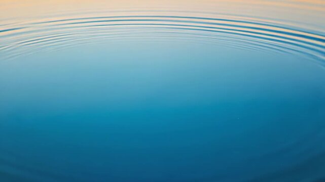Ripples on a calm blue water surface creating a mesmerizing circular pattern