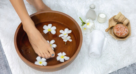 Panorama top view woman indulges in blissful foot massage at luxurious spa salon while masseur give reflexology therapy in gentle day light ambiance resort or hotel foot spa. Quiescent