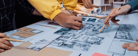 A vibrant collaborative design session showcasing diverse hands engaged in creating architectural blueprints and models, highlighting teamwork and creativity in a bright workspace. SACTR