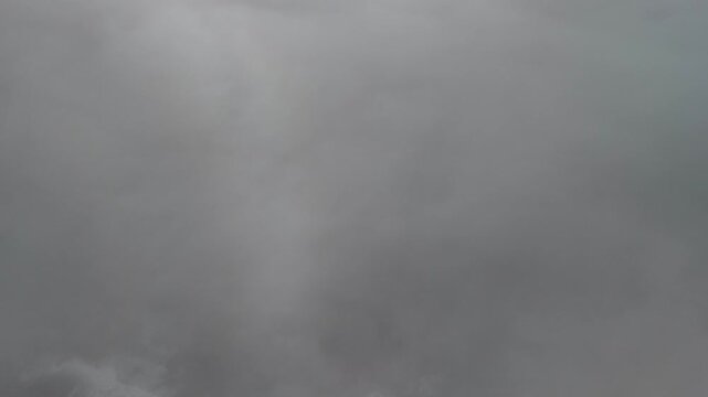 Aerial drone descending through fog along coastline Portugal