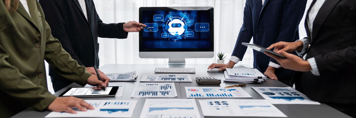Panorama shot analyst team utilizing BI Fintech to analyze financial report with laptop. Businesspeople analyzing BI data dashboard displayed on laptop screen for business insight. Prodigy