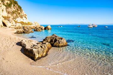 Rocks in crystal clear sea water on beach in Agios Nikitas village, Lefkada island, Greece