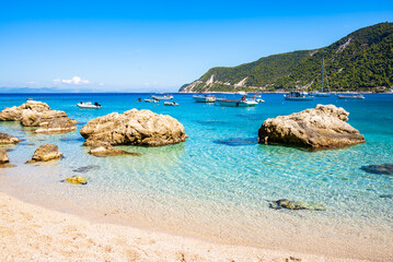Rocks and stones in crystal clear turquoise sea water of Agios Nikitas beach, Lefkada island, Greece
