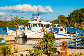 Traditional Greek fishing boats anchoring in Nidri port before sunset, Lefkada island, Greece