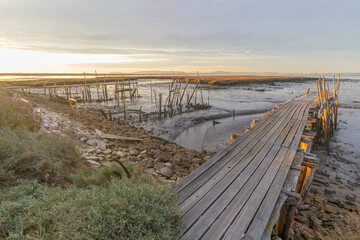 Fototapeta premium Carrasqueira palafitic port wooden pier sunset in portugal