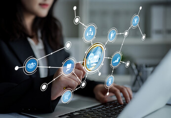 A businesswoman focuses on her laptop, as she engages with digital data insights and virtual graphics, showcasing innovative technology in a modern office setting. Crux