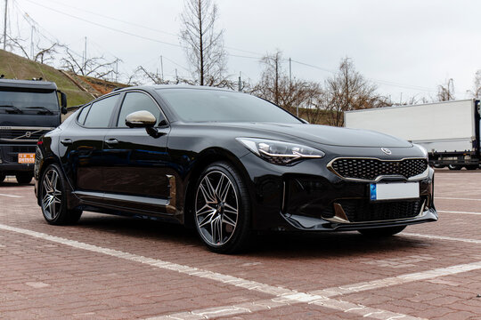 March 28, 2021, Seoul, South Korea - Black Kia Stinger Meister 2.5T car parked in a lot with trucks in the background