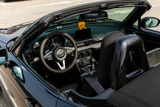 March 26, 2021, Seoul, South Korea - Interior view of a black Mazda MX-5 convertible with a Kakao Friends Ryan figure on the dashboard