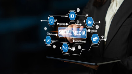 A professional individual interacts with a futuristic social media interface displaying various icons. This image represents modern digital marketing and online connectivity. Tessel