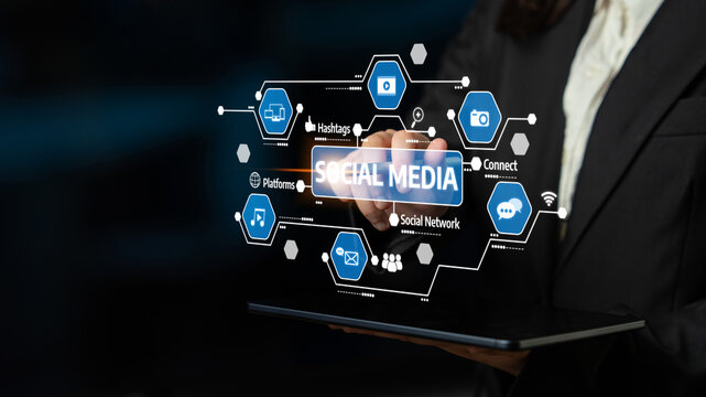 A professional individual interacts with a futuristic social media interface displaying various icons. This image represents modern digital marketing and online connectivity. Tessel - Powered by Adobe
