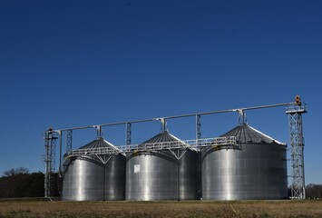 grain silos in the field, dark blue skies © bybarn
