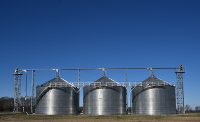 grain silos in the field of a farm © bybarn