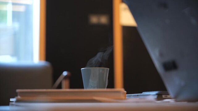 Steaming coffee cup on coffee table