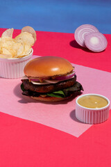 Juicy Artisanal Cheeseburger against Pastel Pink