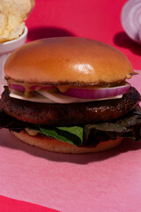 Vibrant Food: High-End Handmade Burger against Seamless Pink