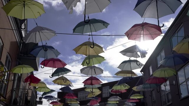 Umbrellas hanging in the sky. Street in the city of Vejla in Denmark
