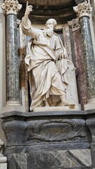 Rome, Italy &ndash; 14 January 2025. In San Giovanni in Laterano, Saint Thomas is depicted in marble holding a square and scroll, raising one finger in a niche framed by green marble columns and dark veined