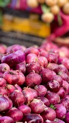 High Stack of Red Onions on Gray Background with Blurred Backdrop