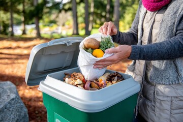 Individual disposes food scraps into compost bin for recycling