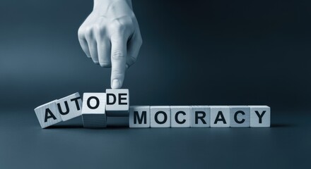 Concept of Democracy Transitioning to Autocracy Represented by Wooden Blocks and Hand Manipulation in Studio Setting