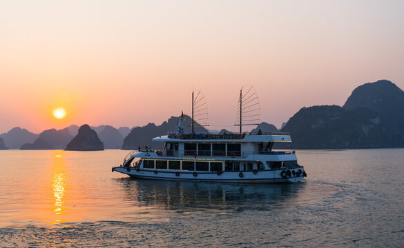 A sunset and a boat at Ha Long Bay, Vietnam
