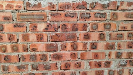 Detailed view of structural brickwork highlighting the grainy texture of the clay and the bonding mortar