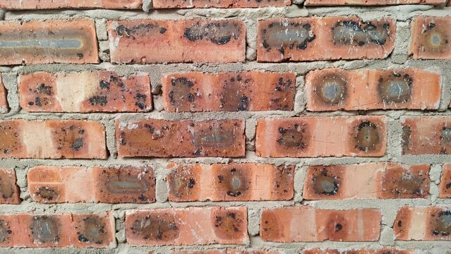Detailed view of structural brickwork highlighting the grainy texture of the clay and the bonding mortar