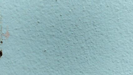 High-angle close-up of a matte teal wall showing a heavy orange-peel texture and consistent pigment distribution