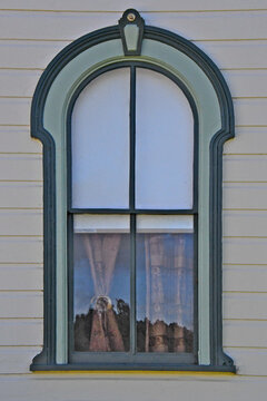 Rounded arch window with faux keystone to provide visual emphasis and add a hallmark of classical design