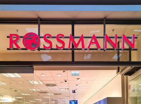 Kiel, Germany - 29. December 2025: Rossmann store sign illuminating shopping mall in Kiel
