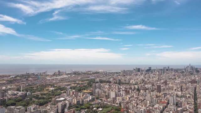 Aerial hyperlapse with panoramic views of Buenos Aires as the drone flies backwards over the Recoleta neighborhood, revealing dense city blocks and the urban skyline.