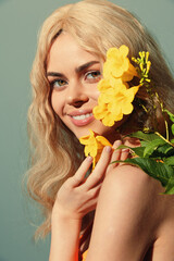 Beautiful woman with long blonde hair, smiling with yellow flowers, perfect for spring or summer themes, showcasing joy and nature.