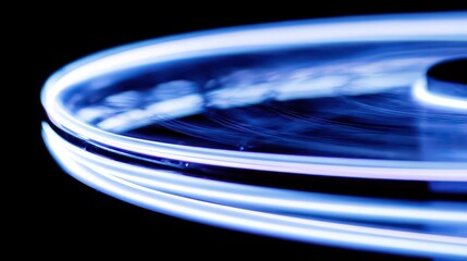 Abstract Light Painting in Blue and White on Black Background with Circular Motion Creating Swirling Effect